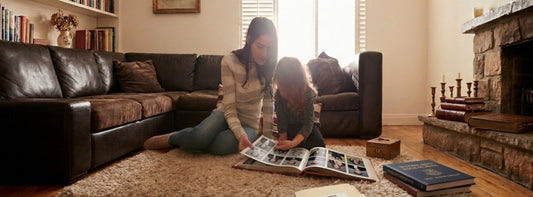 Mother and daughter looking through school yearbooks.